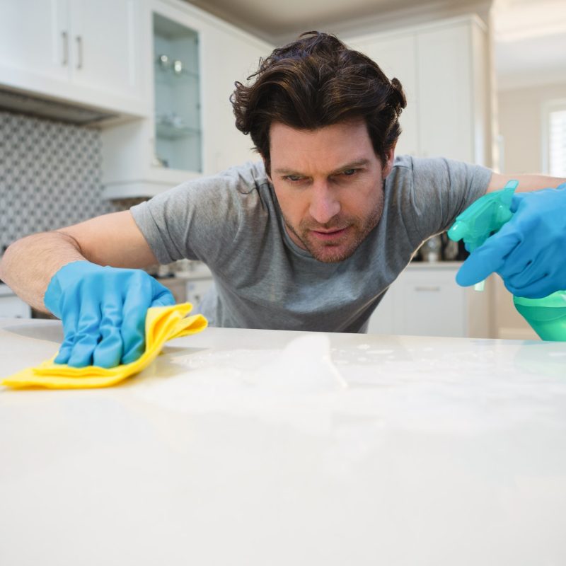 man-cleaning-kitchen-worktop-at-home.jpg man-cleaning-kitchen-worktop-at-home.jpg